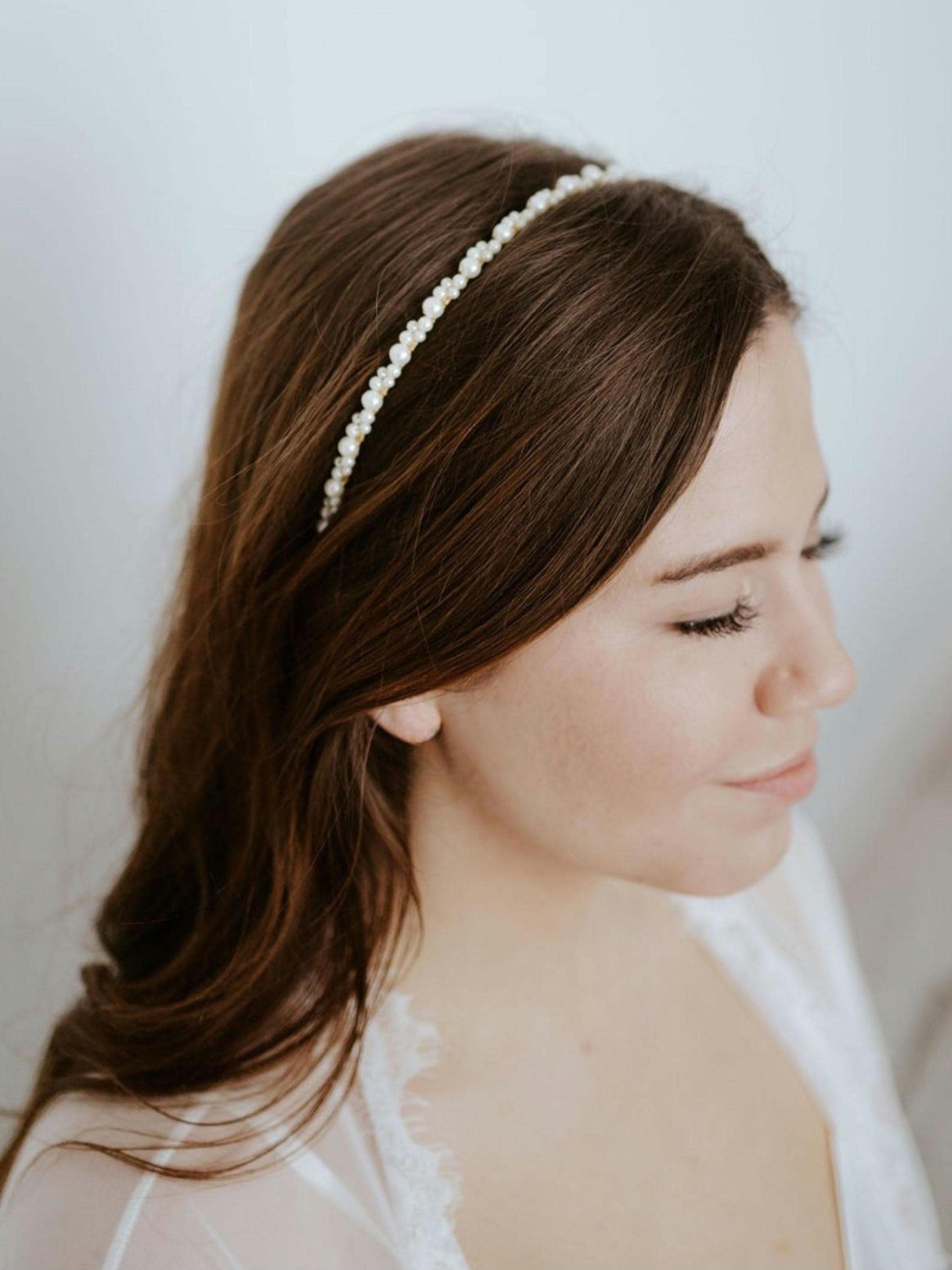 Model with textured waves wearing a thin pearl bridal headband, showcasing a simple yet elegant accessory perfect for adding subtle sparkle to any bridal hairstyle. Ideal for understated, romantic wedding looks.