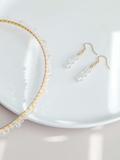 Gold headband and earrings on a white plate